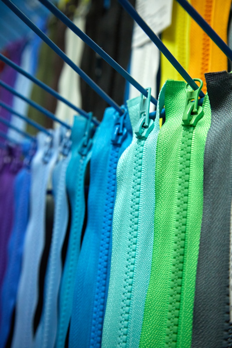 a row of colorful zippers hanging on a clothes line